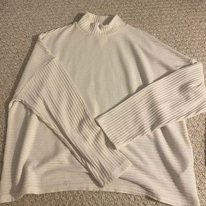 White flowy turtleneck sweater